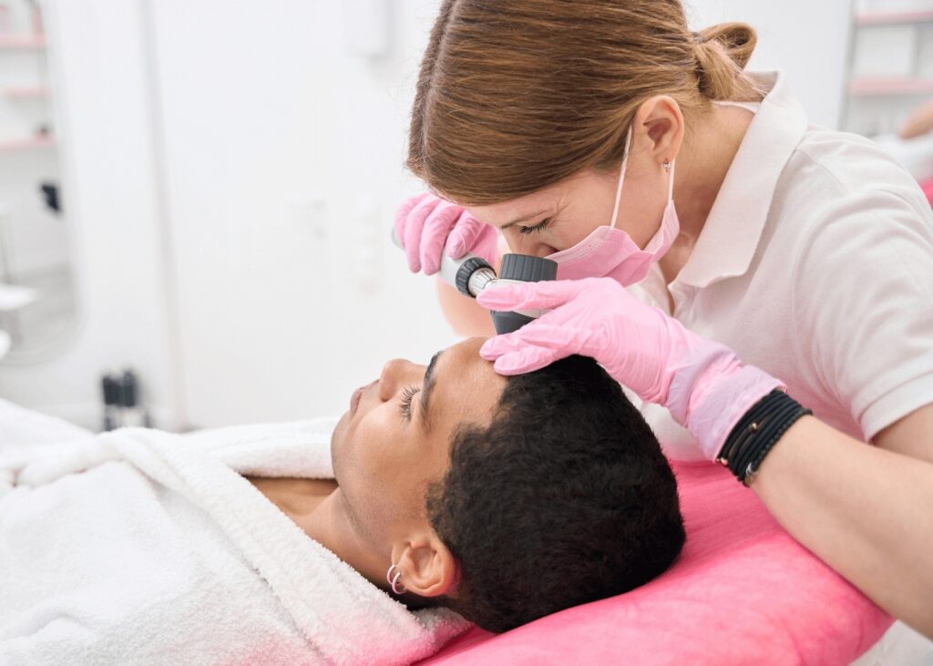 Dermatologist performing skin exam on patient in medical clinic in New Lenox.