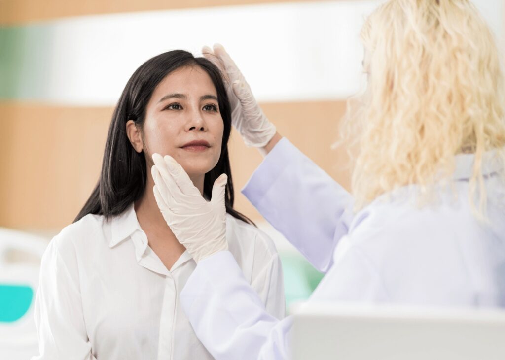 Dermatologist performing skin exam on patient in a clinic setting in New Lenox.